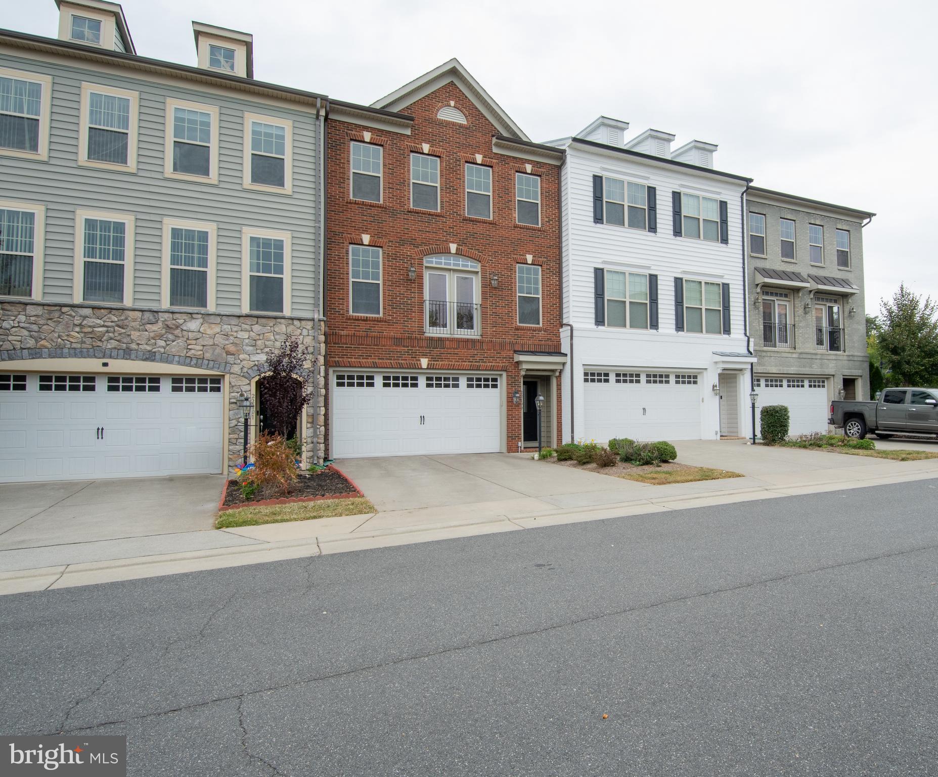 22199 Falling Terrace Ashburn, VA 20148 - Photo 1 of 58 a front view of a building with lot of cars