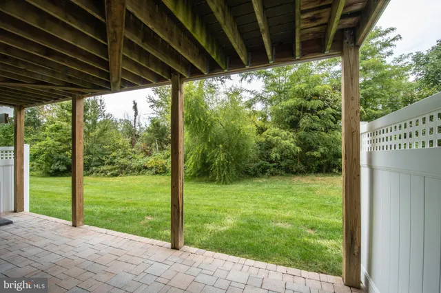 a view of a big yard with large trees