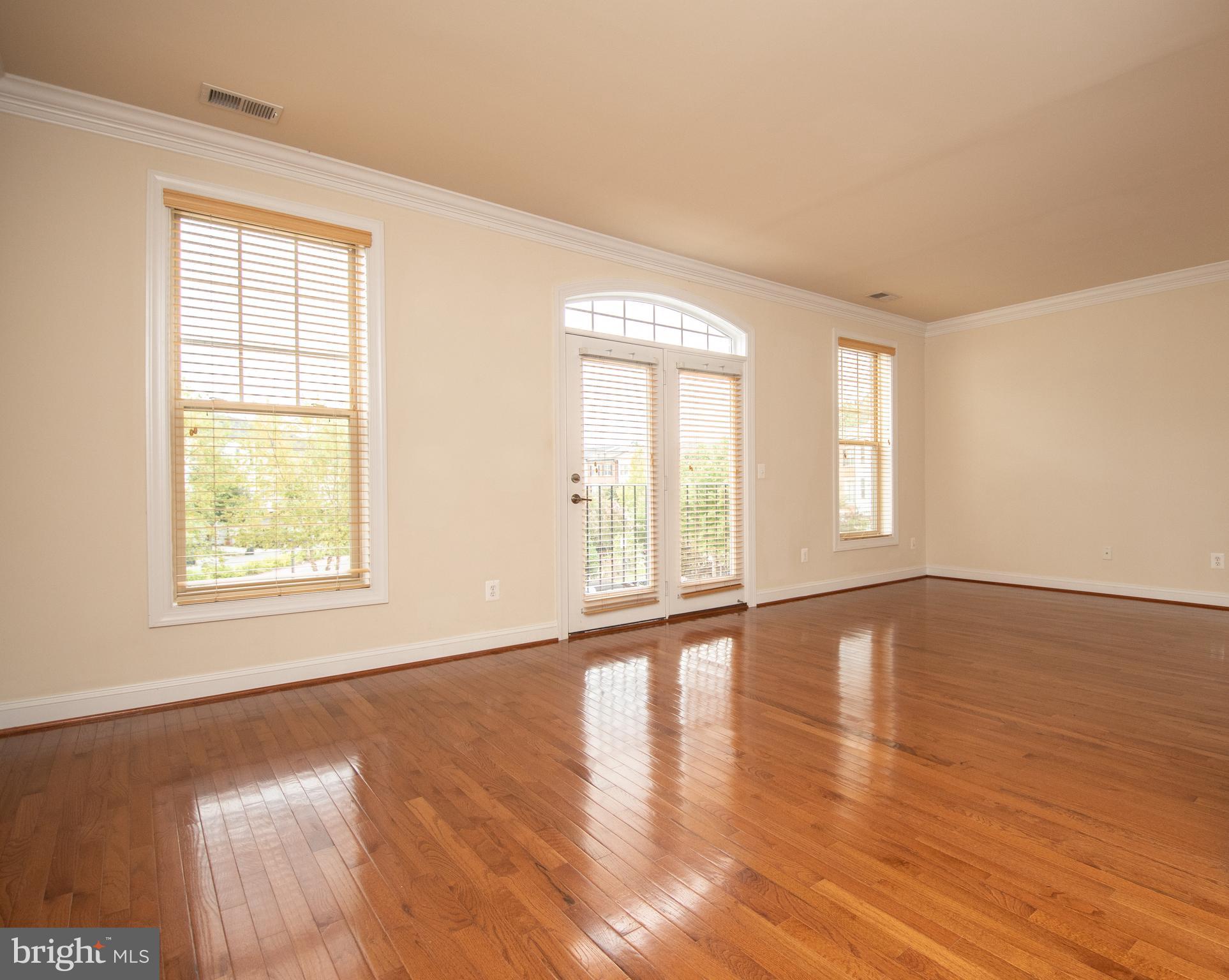22199 Falling Terrace Ashburn, VA 20148 - Photo 20 of 58 a view of an empty room with wooden floor and a window