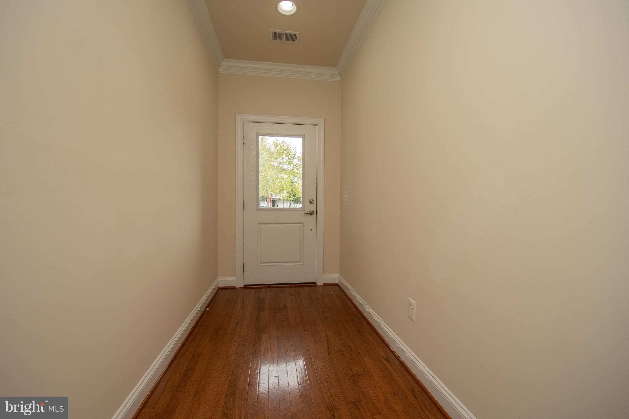 22199 Falling Terrace Ashburn, VA 20148 - Photo 2 of 58 a view of a hallway with wooden floor and a window