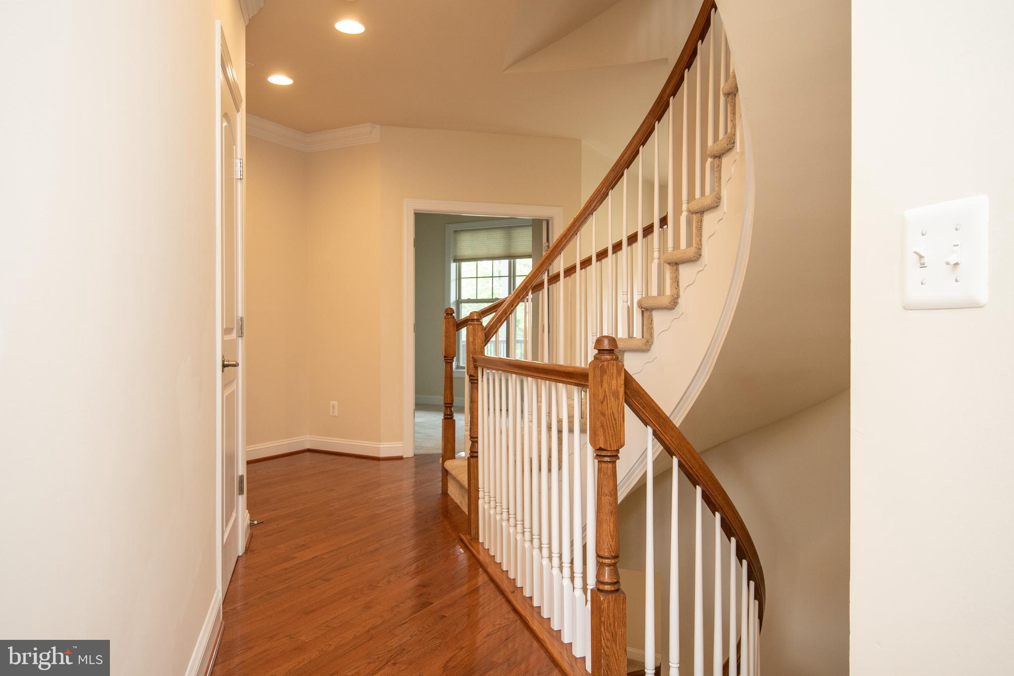 22199 Falling Terrace Ashburn, VA 20148 - Photo 3 of 58 a view of a hallway with wooden floor and staircase