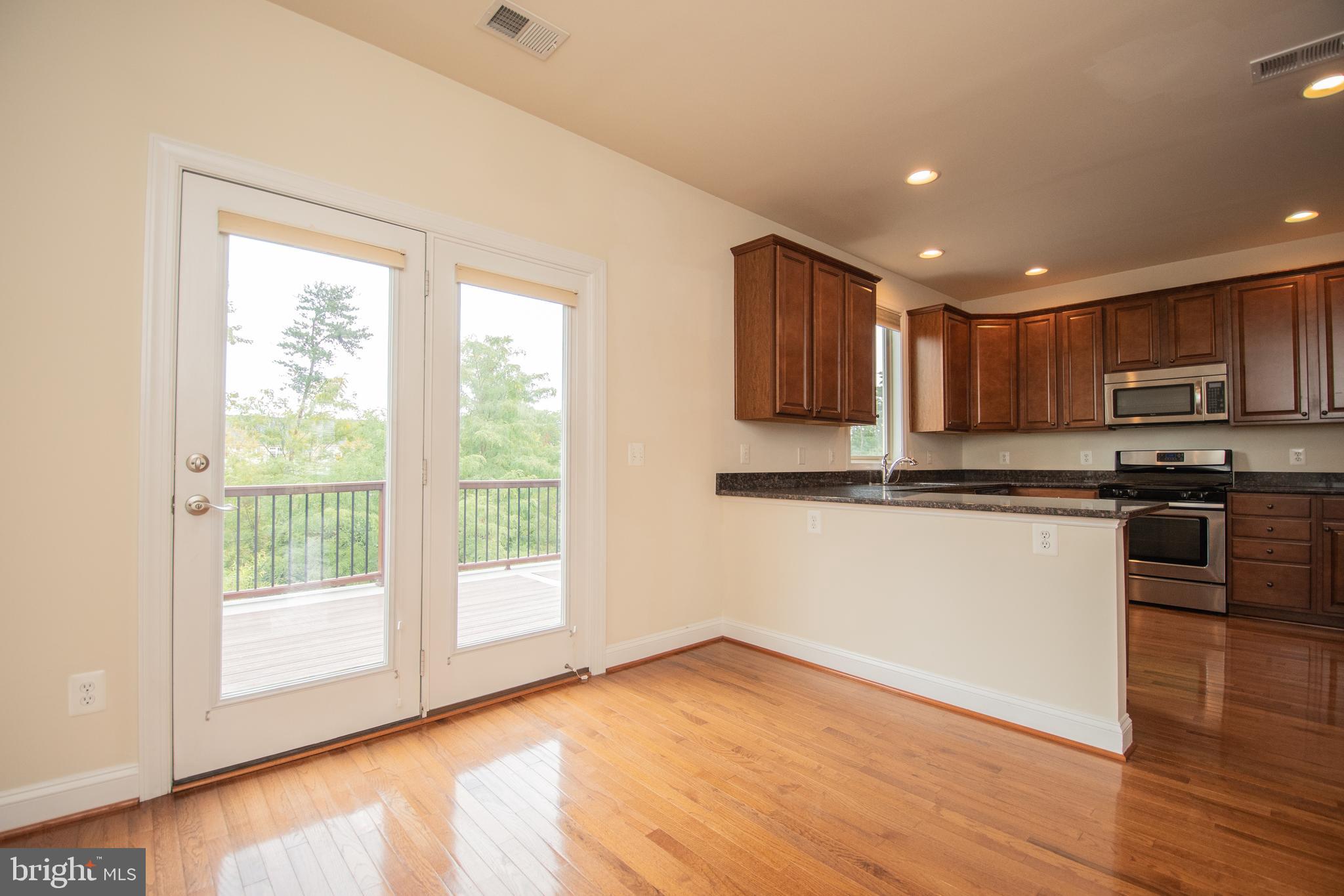 22199 Falling Terrace Ashburn, VA 20148 - Photo 31 of 58 a kitchen with stainless steel appliances granite countertop a refrigerator microwave and sink