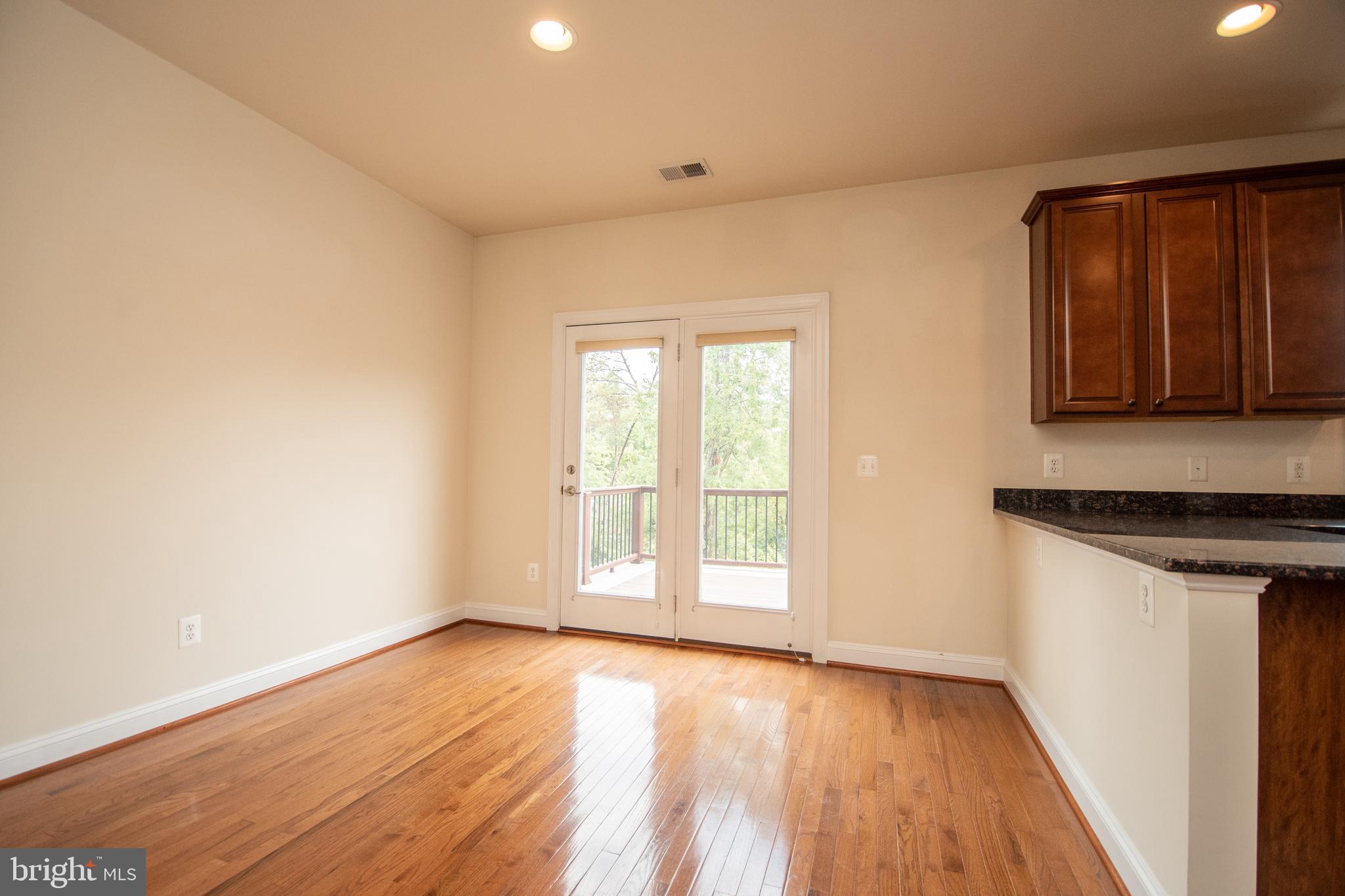 22199 Falling Terrace Ashburn, VA 20148 - Photo 32 of 58 an empty room with wooden floor and window