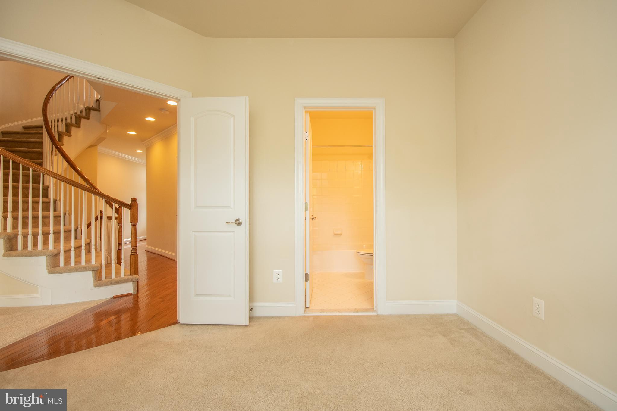 22199 Falling Terrace Ashburn, VA 20148 - Photo 10 of 58 a view of an empty room with wooden floor and a bathroom