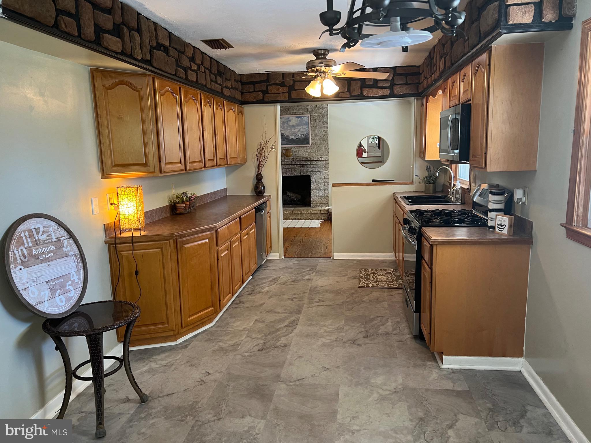 425 Beechcroft Road Winchester, VA 22601 - Photo 6 of 21 a kitchen with refrigerator cabinets and a stove
