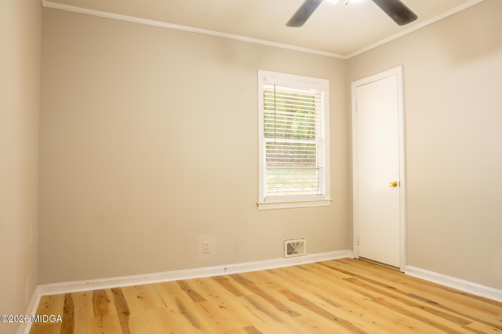 3319 Mohawk Road Macon, GA 31217 - Photo 29 of 38 a view of an empty room with wooden floor and a window