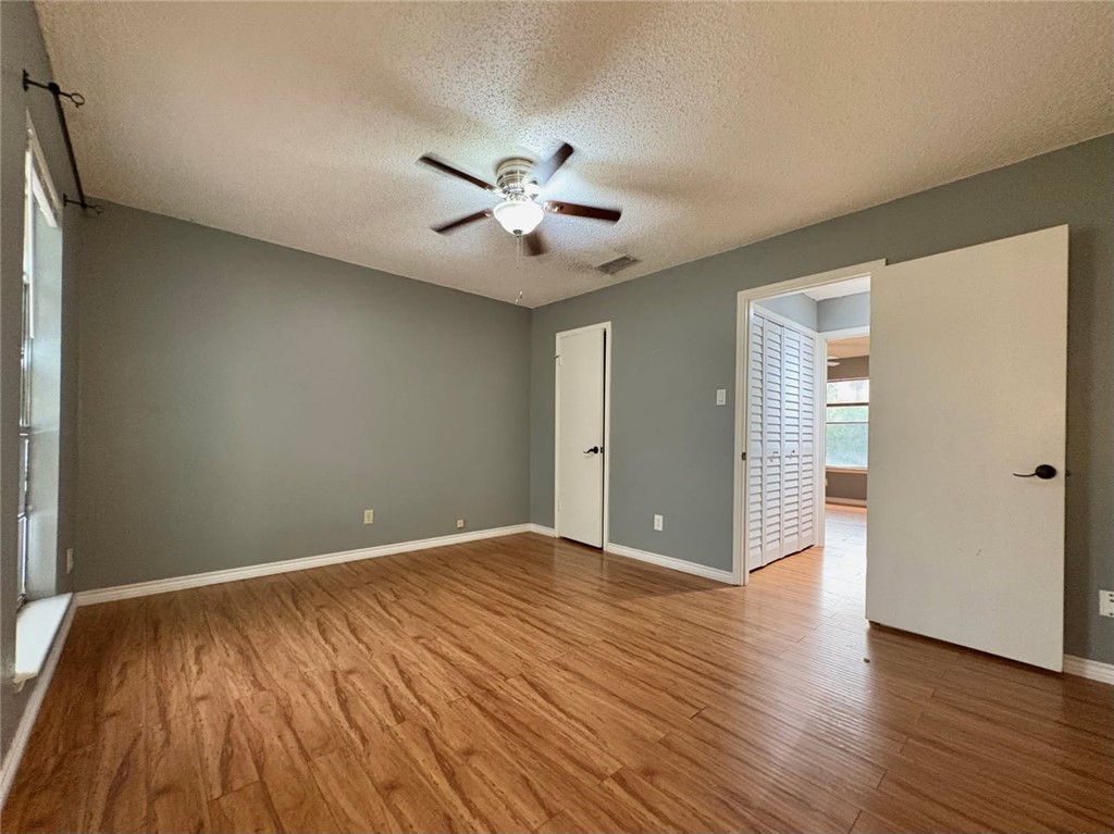 6702 Everhart Road, Unit H105 Corpus Christi, TX 78413 - Photo 15 of 18 a view of an empty room with wooden floor