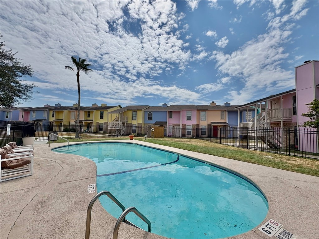 6702 Everhart Road, Unit H105 Corpus Christi, TX 78413 - Photo 17 of 18 a swimming pool view with a seating space and a garden view