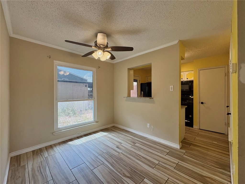 6702 Everhart Road, Unit H105 Corpus Christi, TX 78413 - Photo 5 of 18 an empty room with wooden floor and windows