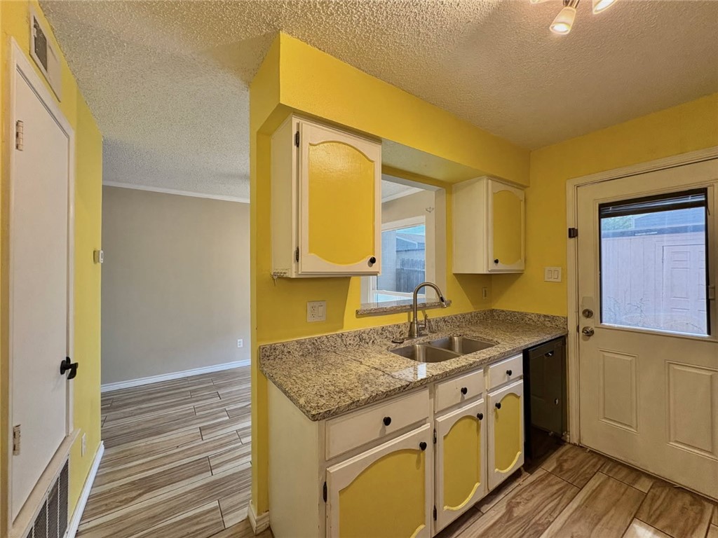 6702 Everhart Road, Unit H105 Corpus Christi, TX 78413 - Photo 6 of 18 a bathroom with a granite countertop sink and a mirror