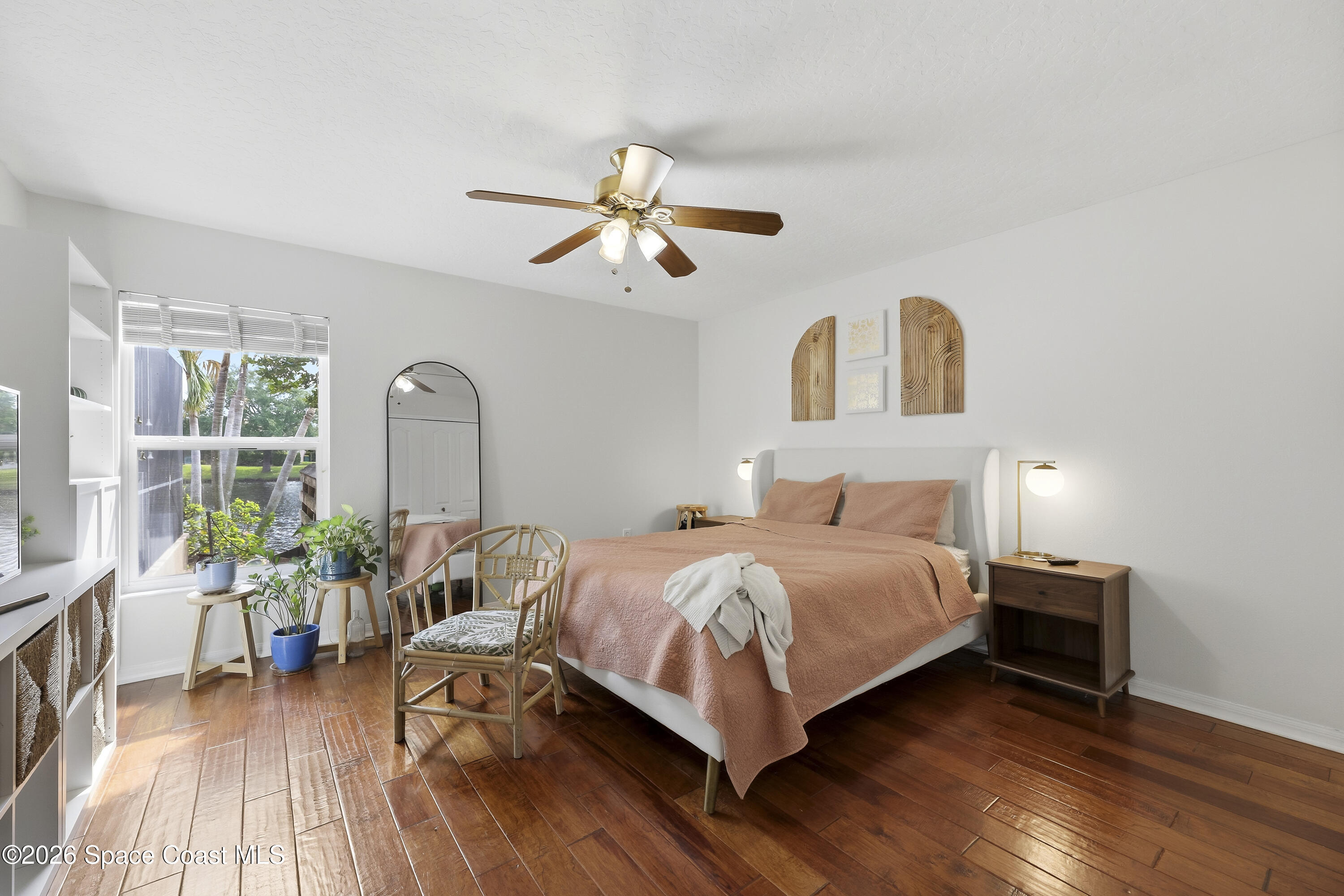 1643 Long Pine Road Melbourne, FL 32940 - Photo 34 of 63 a bedroom with a bed and wooden floor