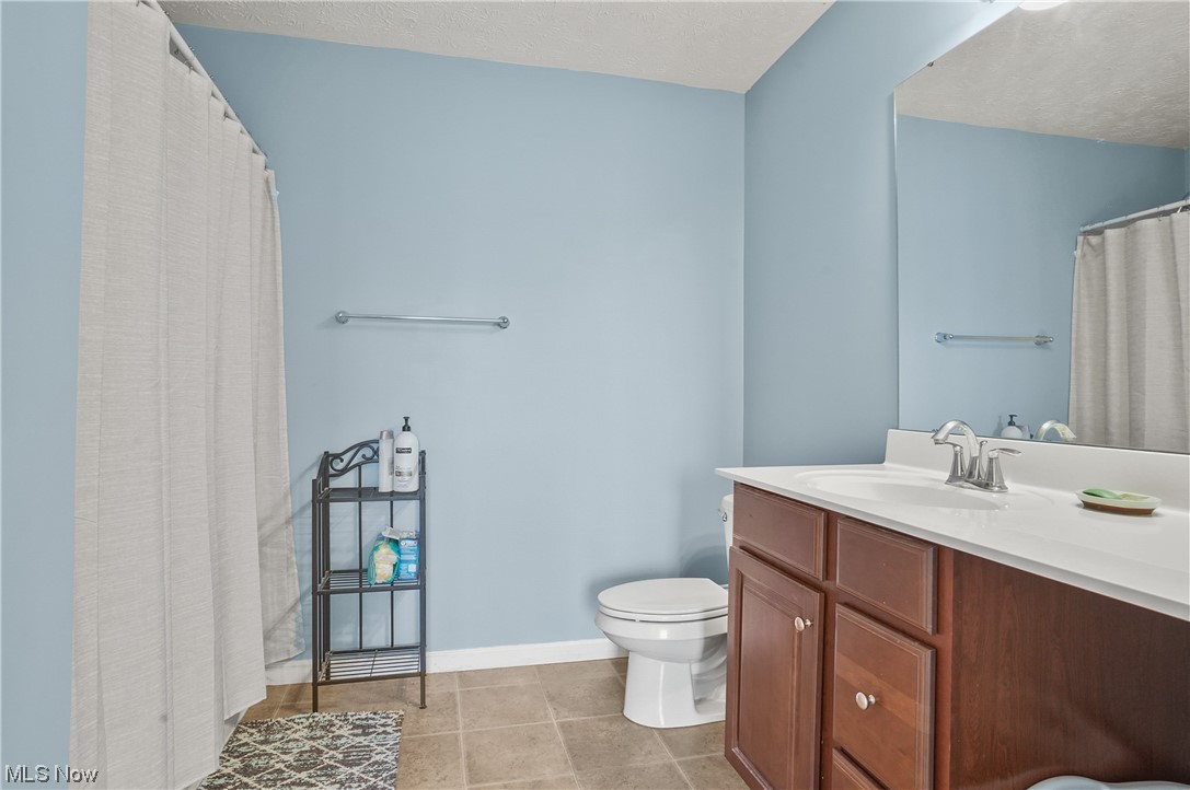 4169 Whitestone Road Kent, OH 44240 - Photo 20 of 33 Bathroom featuring vanity, toilet, and tile floors