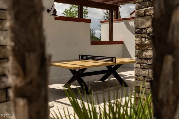 a view of swimming pool with outdoor seating and plants