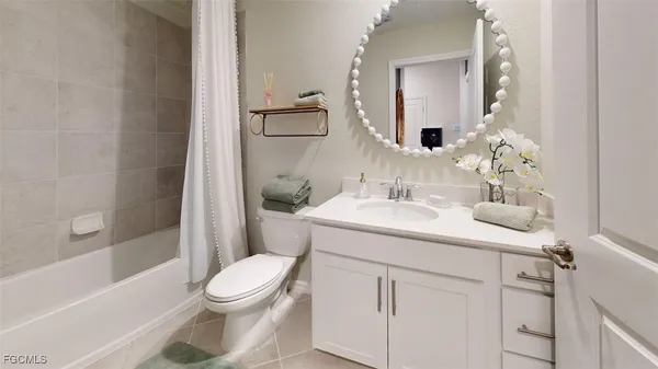 a bathroom with a toilet a sink a vanity and mirror