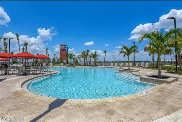 a view of swimming pool with palm trees