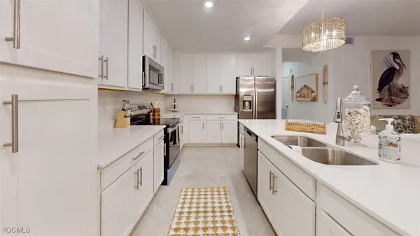a kitchen with a sink cabinets and stainless steel appliances