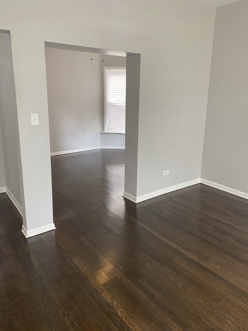 7425 South Princeton Avenue, Unit 2 Chicago, IL 60621 - Photo 16 of 24 an empty room with wooden floor and windows