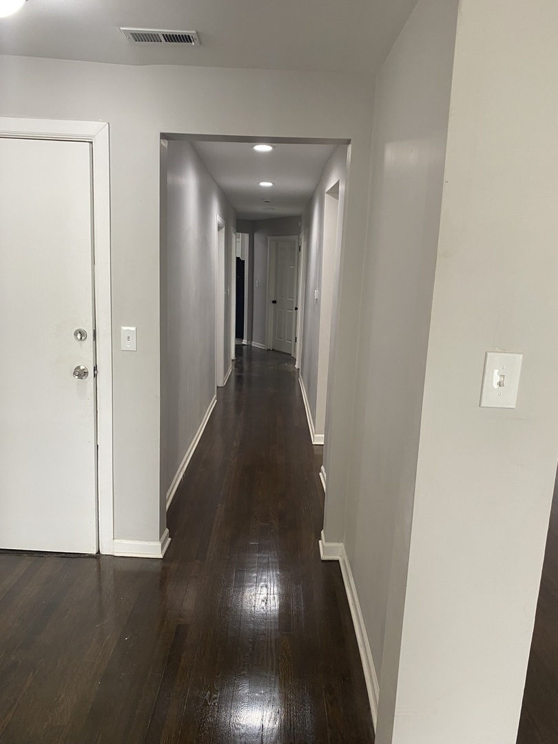 7425 South Princeton Avenue, Unit 2 Chicago, IL 60621 - Photo 18 of 24 a view of a hallway with wooden floor