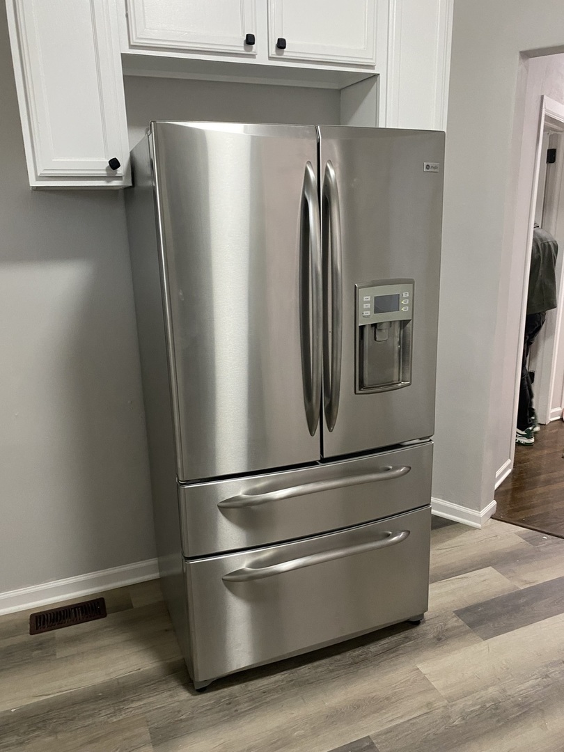 7425 South Princeton Avenue, Unit 2 Chicago, IL 60621 - Photo 10 of 24 a view of a refrigerator in kitchen and an empty room