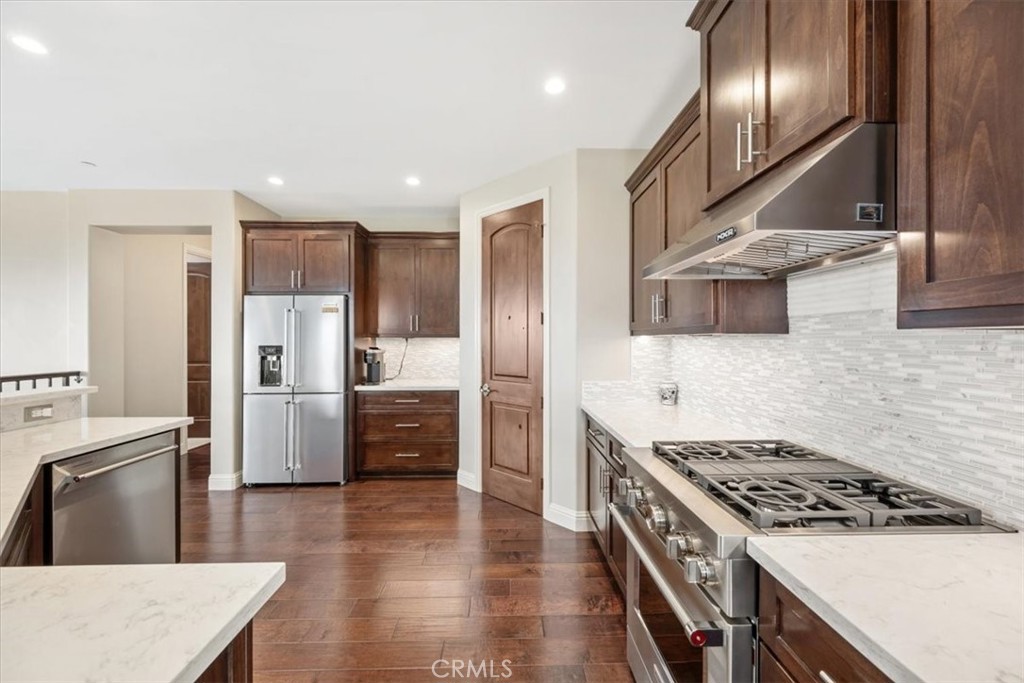 207 Princessa Lane Pismo Beach, CA 93449 - Photo 11 of 38 a kitchen with stainless steel appliances granite countertop a stove a refrigerator and a sink