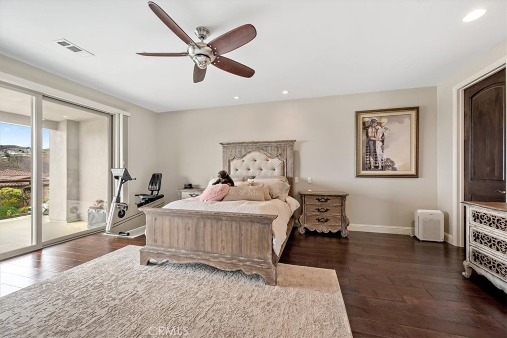 207 Princessa Lane Pismo Beach, CA 93449 - Photo 14 of 38 a bedroom with a bed and wooden floor