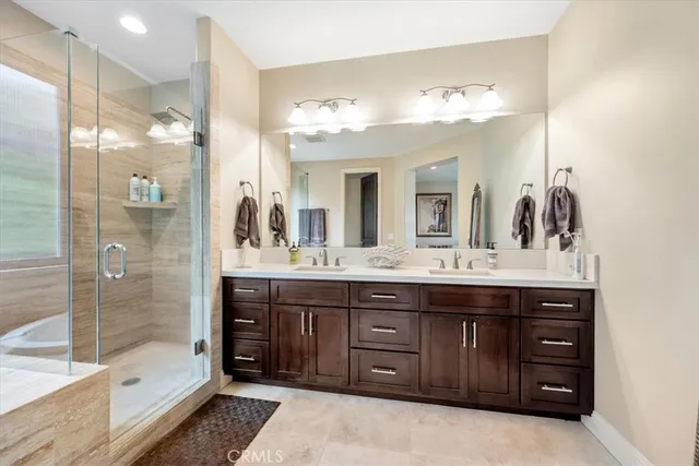 a bathroom with a sink double vanity and a shower
