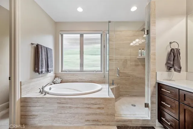 a bathroom with a granite countertop sink a mirror and shower