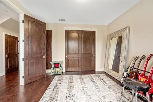 a bedroom with a bed and a dresser