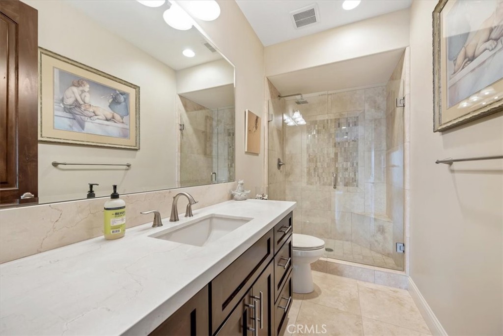 207 Princessa Lane Pismo Beach, CA 93449 - Photo 29 of 38 a bathroom with a granite countertop sink a toilet a shower and a mirror