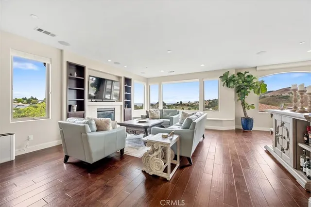a living room with furniture fireplace and a flat screen tv