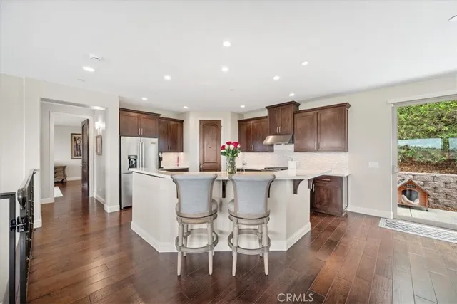 a kitchen with a dining table chairs appliances and cabinets