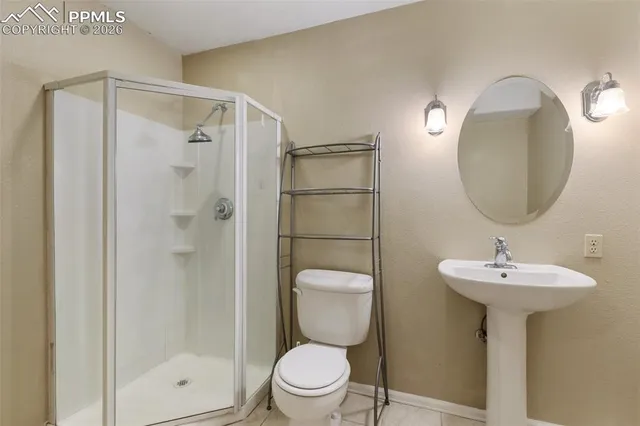 an empty room with a ceiling fan and wooden floor