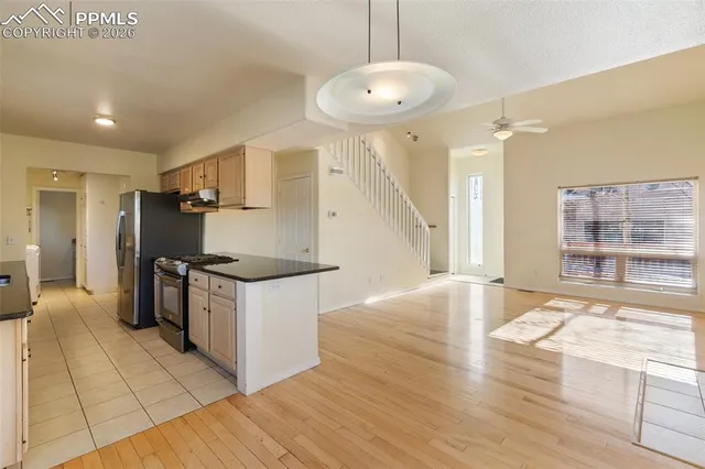 a kitchen with granite countertop a sink and a stove