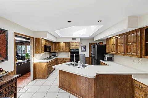 a kitchen with a refrigerator and a sink