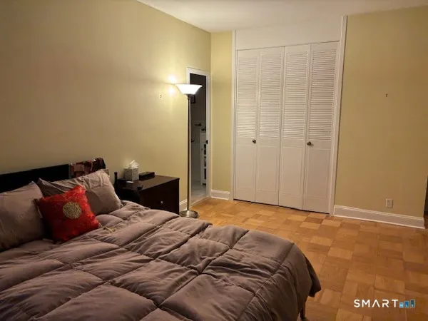 a bedroom with a bed and a night stand