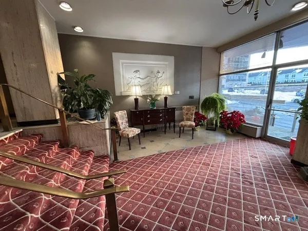 a living room with patio furniture and a potted plant