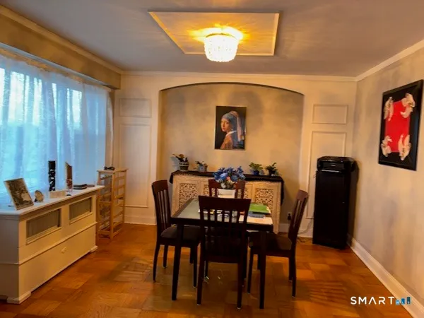 a view of a dining room with furniture and wooden floor