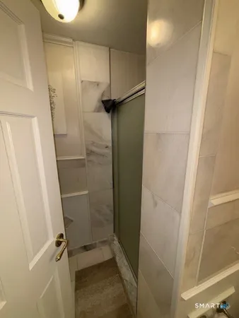 a bathroom with a glass door shower