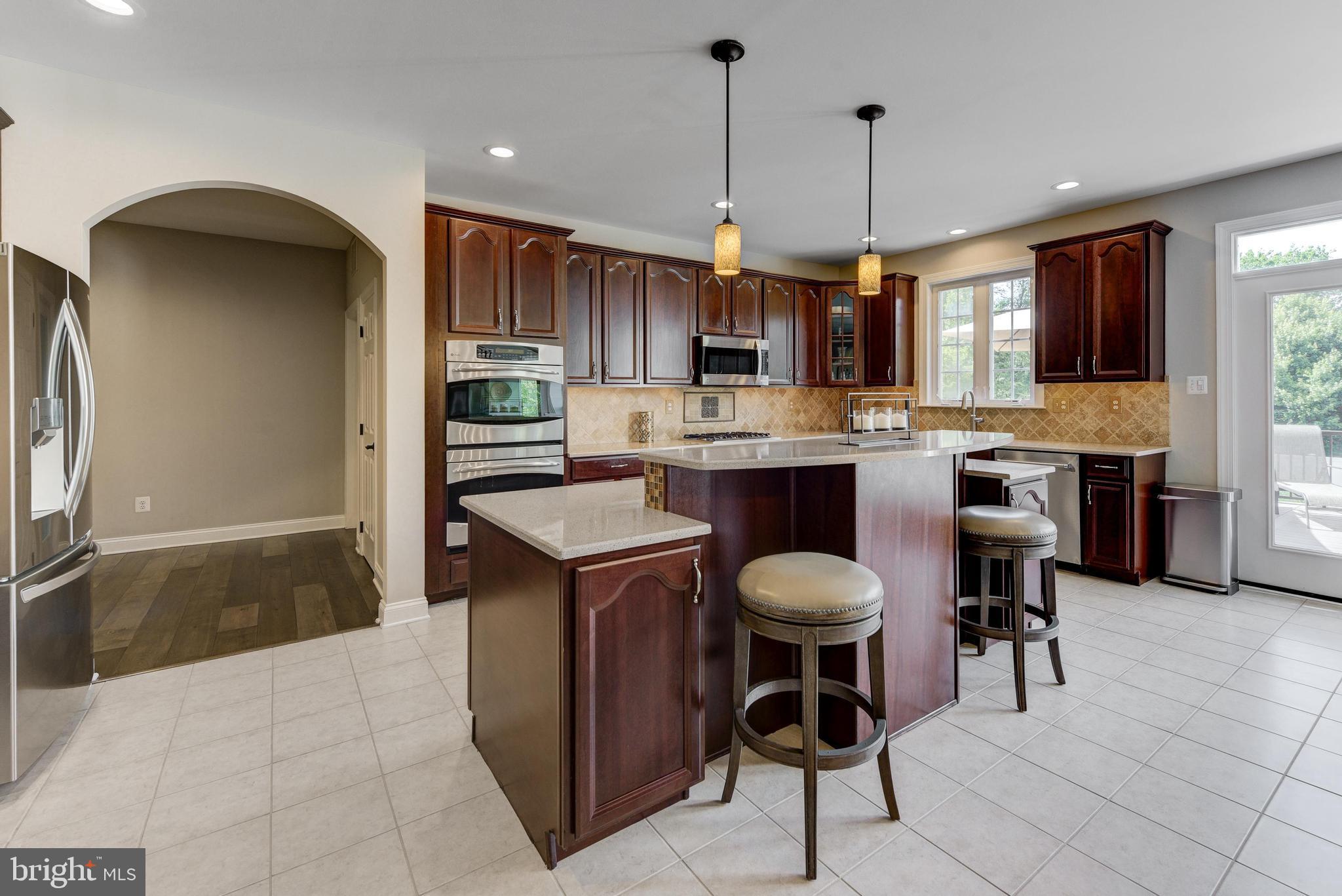811 Castleton Drive Mickleton, NJ 08056 - Photo 16 of 52 a kitchen with kitchen island granite countertop a table and chairs in it