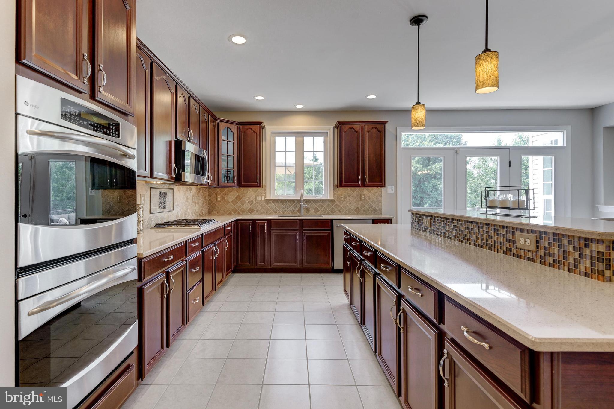 811 Castleton Drive Mickleton, NJ 08056 - Photo 17 of 52 a large kitchen with stainless steel appliances cabinets a sink and a counter top space