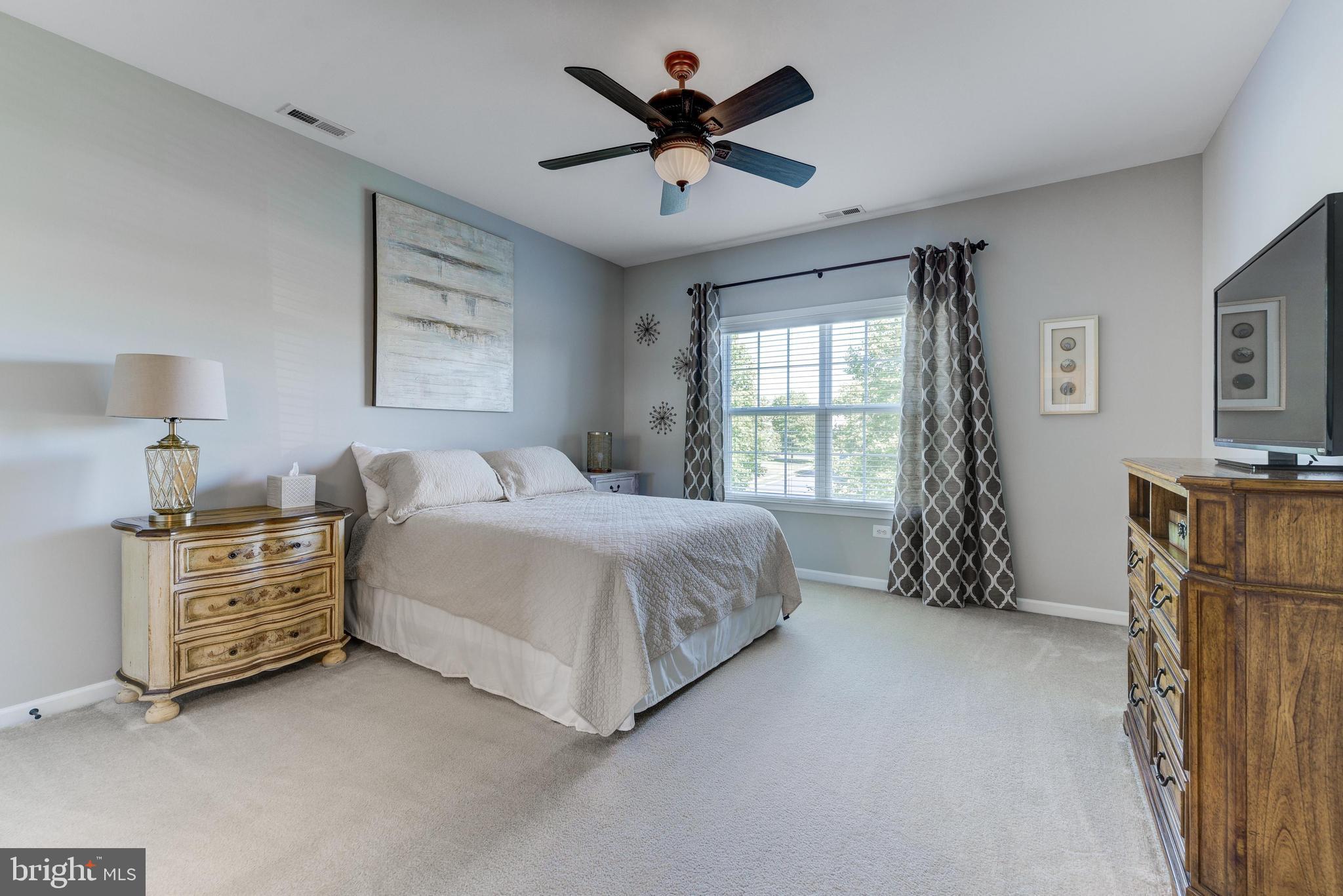 811 Castleton Drive Mickleton, NJ 08056 - Photo 35 of 52 a spacious bedroom with a bed and a chandelier