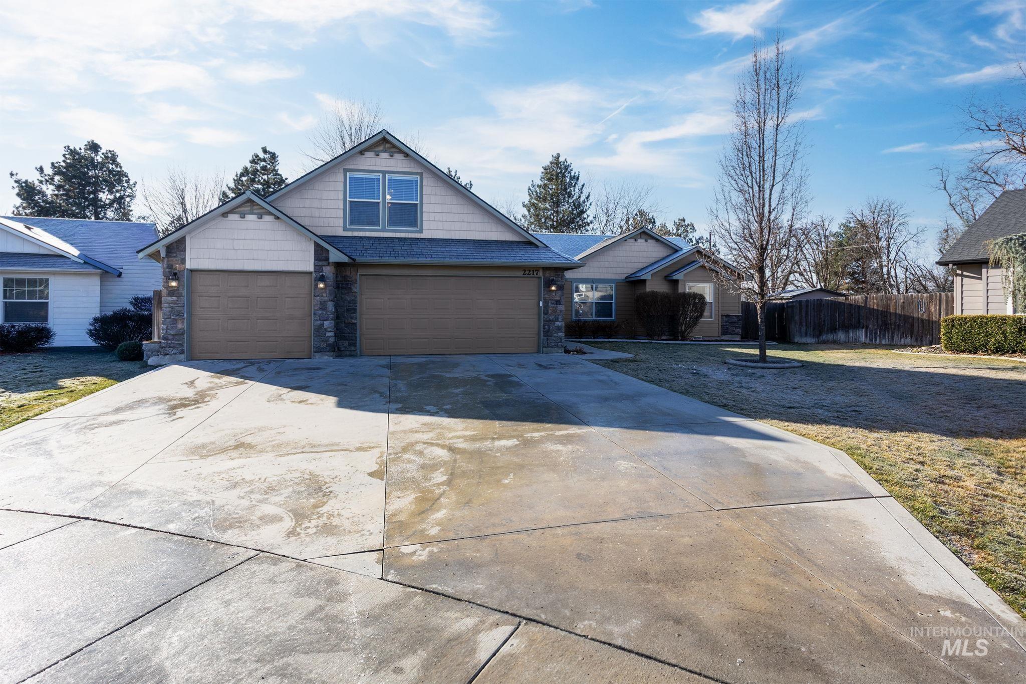 2217 East Satterfield Street Meridian, ID 83646 - Photo 1 of 33 Craftsman-style house featuring driveway and stone siding