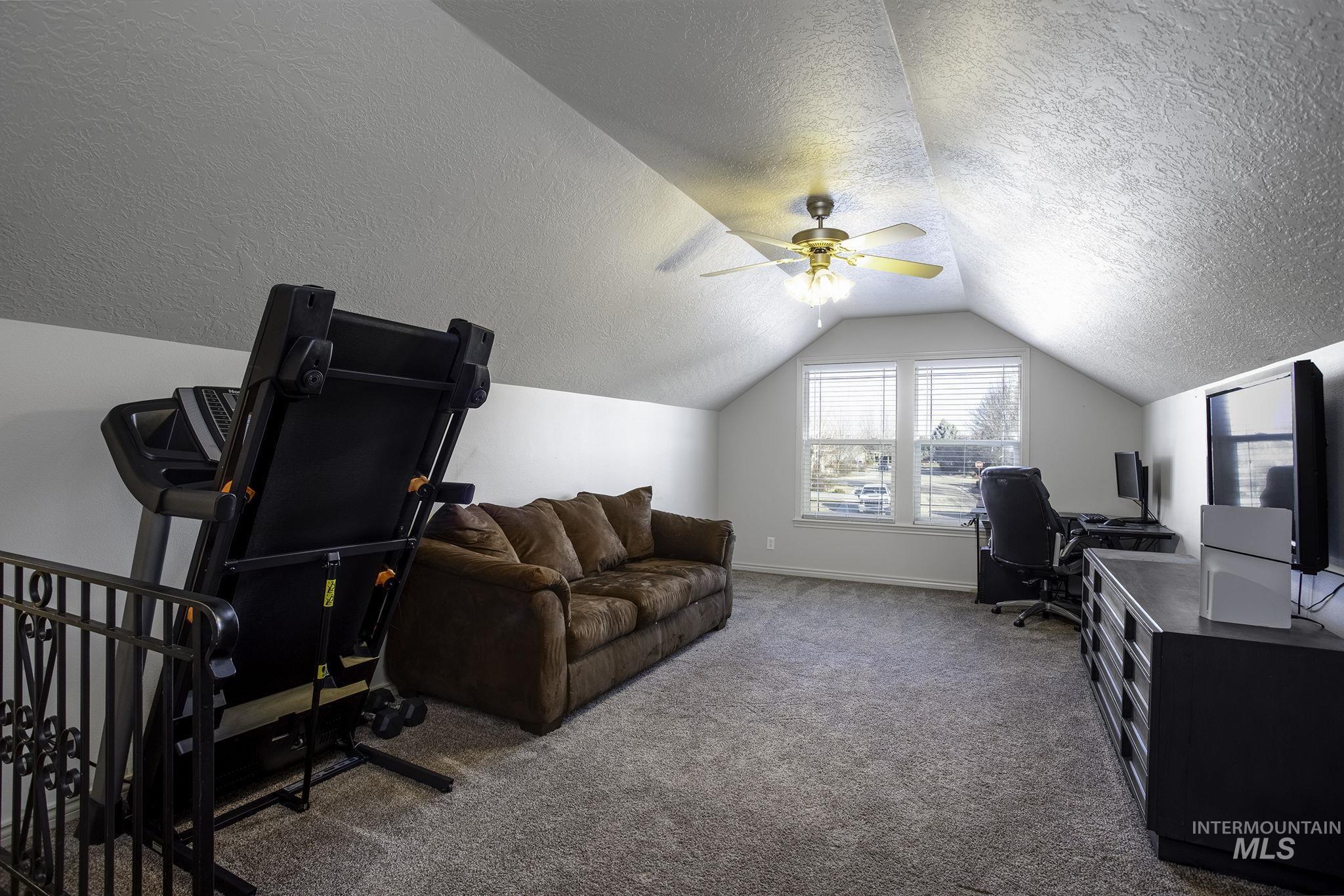 2217 East Satterfield Street Meridian, ID 83646 - Photo 19 of 33 Office featuring carpet floors, lofted ceiling, a ceiling fan, and a textured ceiling