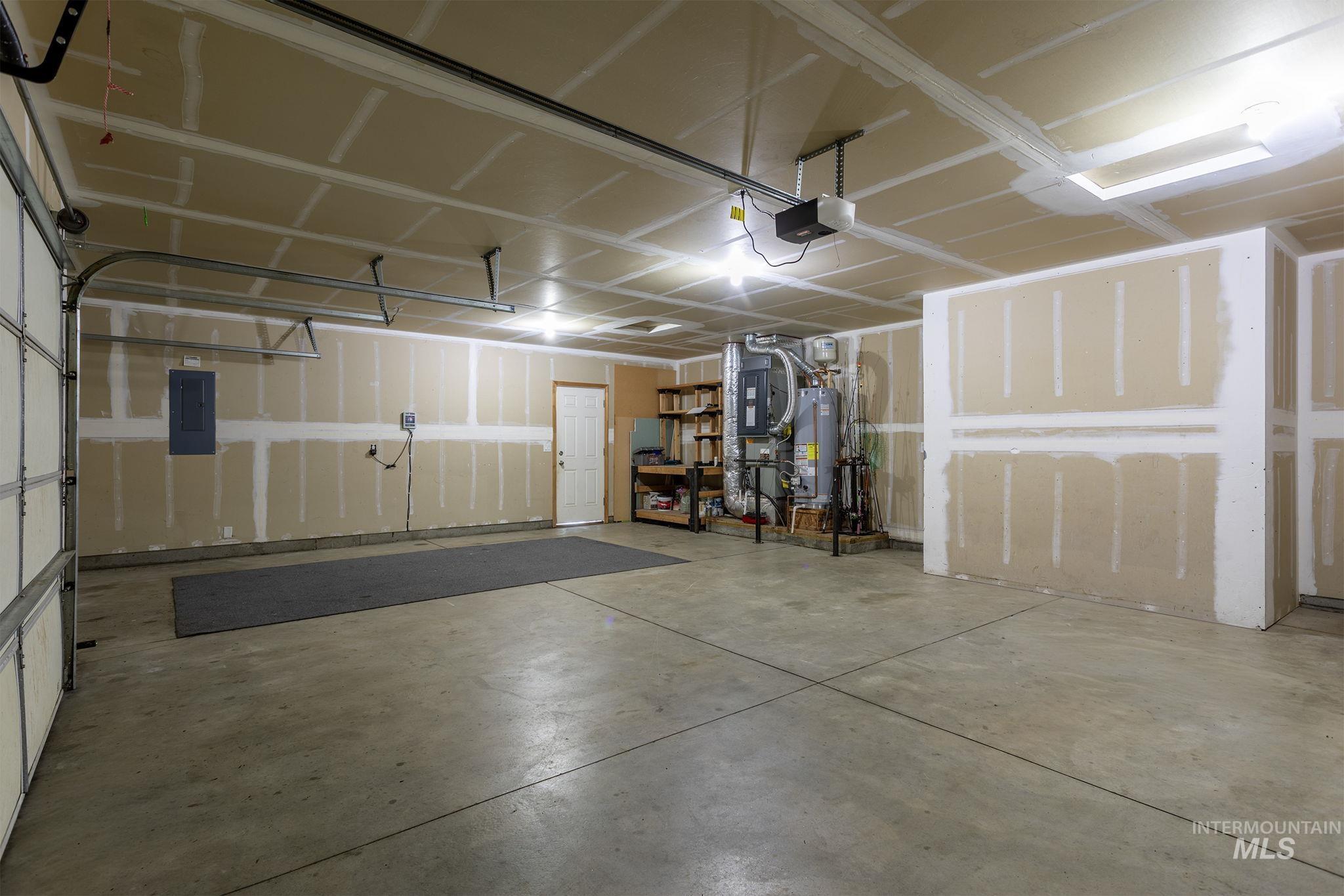 2217 East Satterfield Street Meridian, ID 83646 - Photo 25 of 33 Garage with electric panel, water heater, a garage door opener, and heating unit