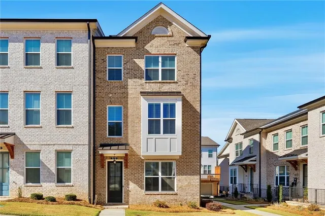 a front view of a residential apartment building with a yard