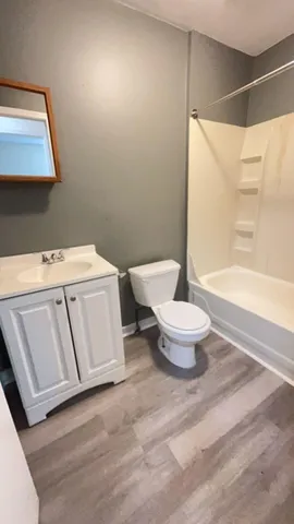 a white toilet sitting next to a bathroom sink