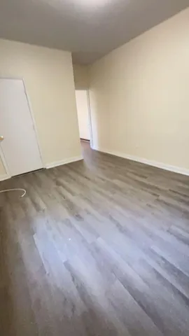an empty room with wooden floor