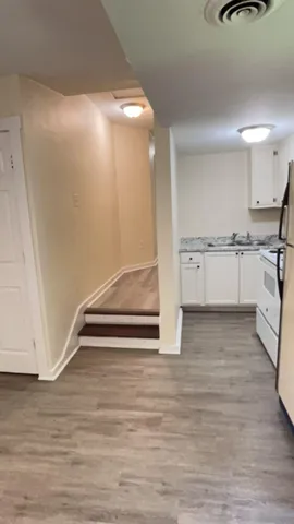 a view of kitchen with wooden floor and electronic appliances