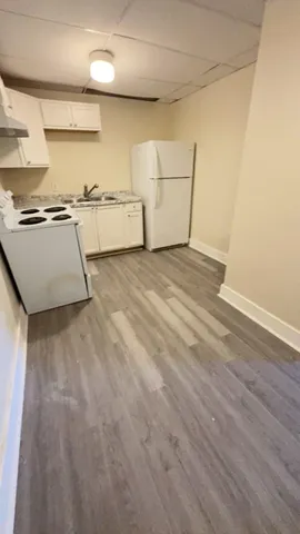 a view of a storage & utility room with sink dryer and washer