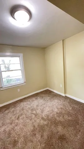 an empty room with a empty space and windows